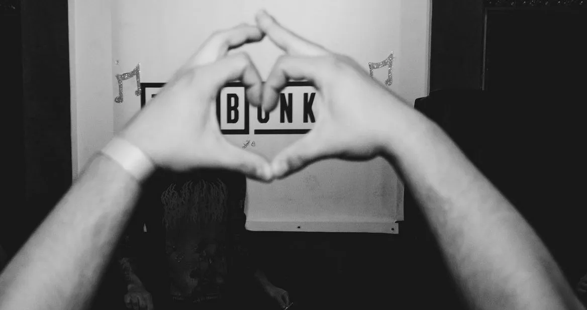 Hands forming a heart in front of The Bunker logo during an event